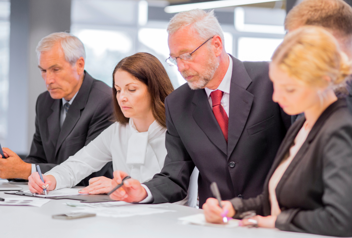 serious-businesspeople-working-project-desk-office 1